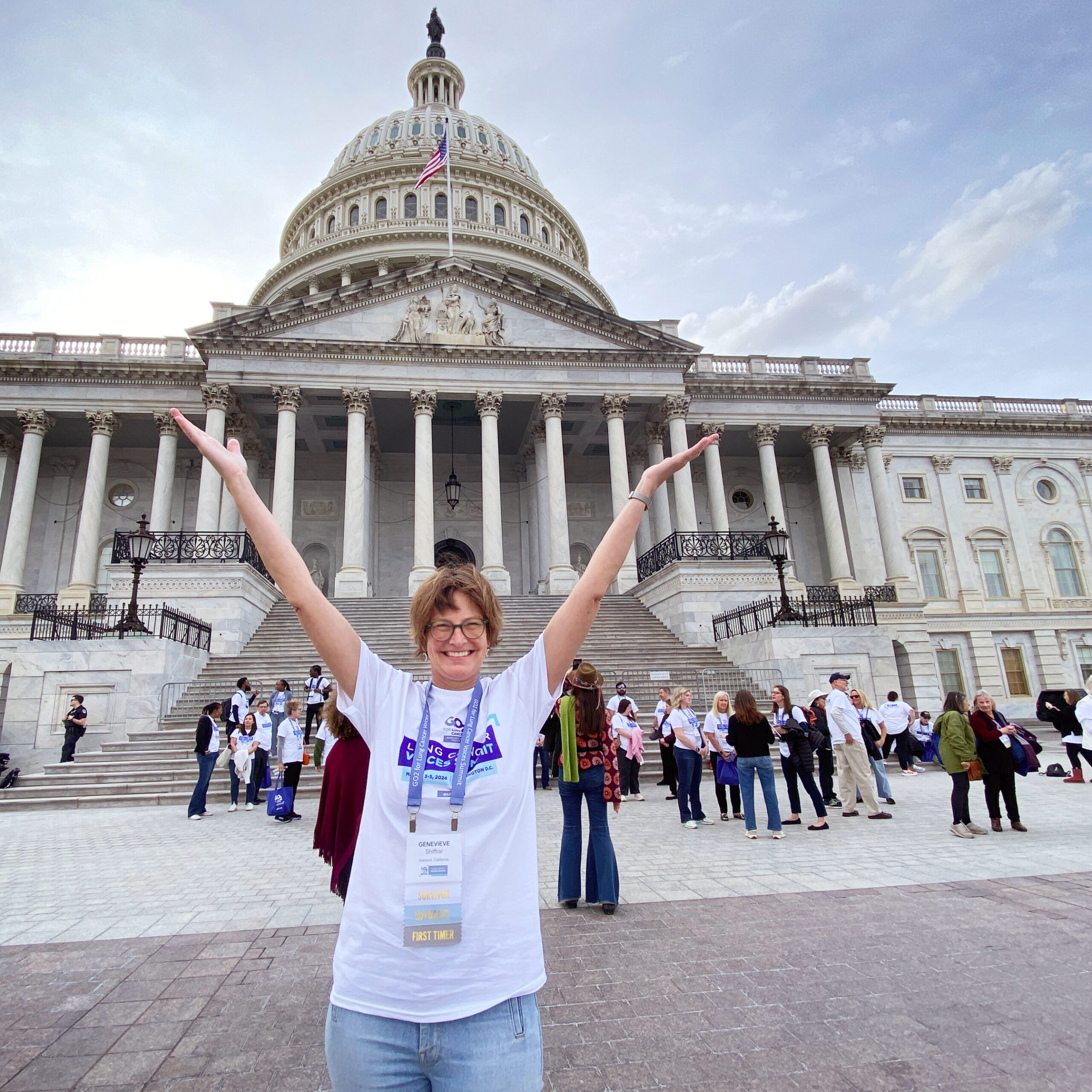 Genevieve standing with hands up in front of Capitol