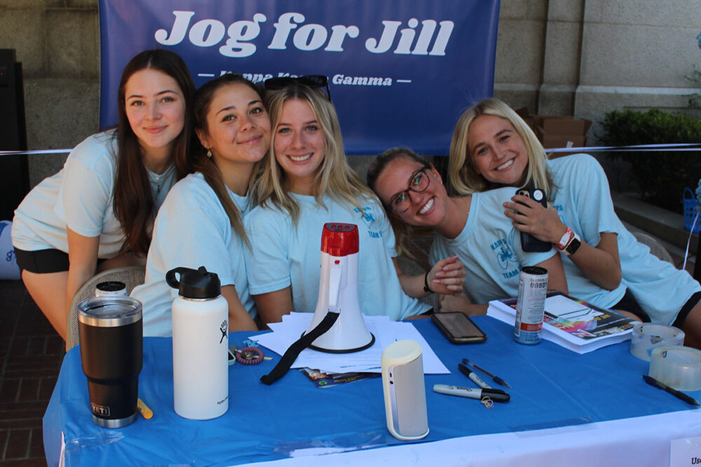 Women in front of Jog for Jill sign