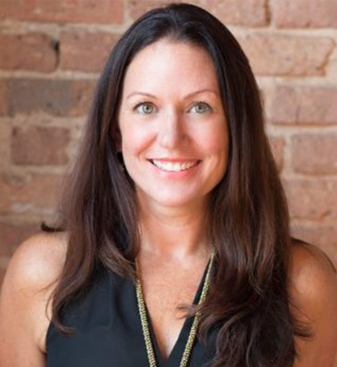 Lacie Flannery headshot with brick background
