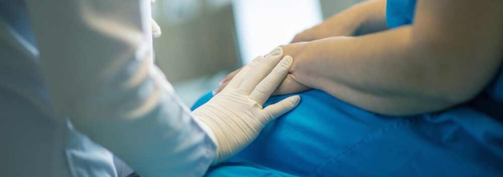 Doctor with hand on a patient