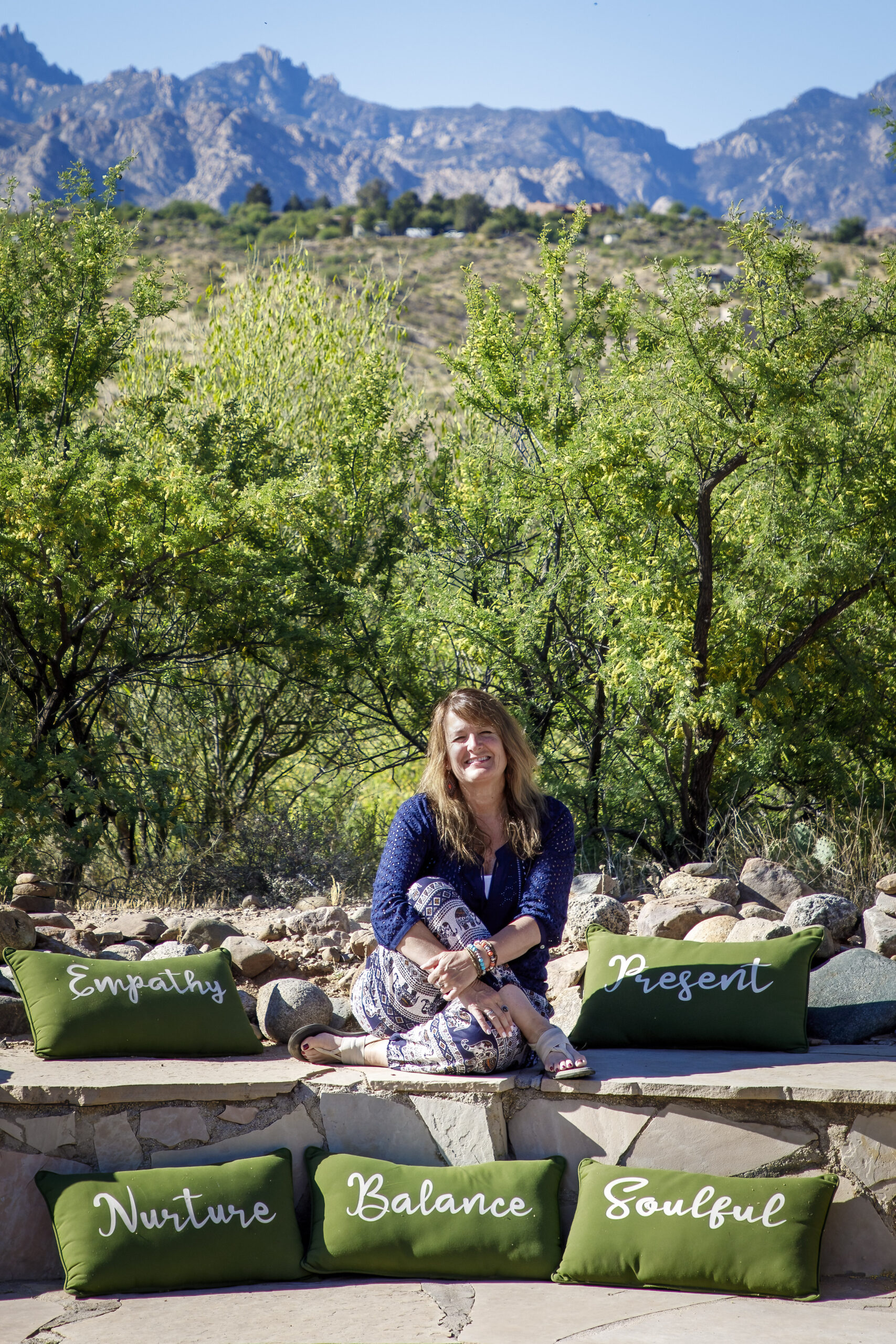 Susan Smedley sitting with mountain background