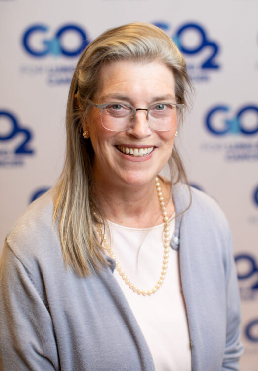 Tamara with GO2 Voices Summit backdrop