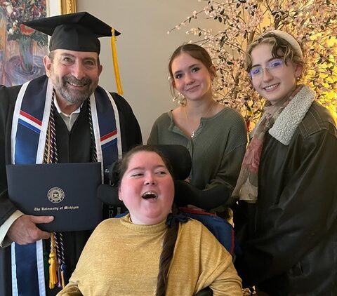 Jim with his daughters at graduation