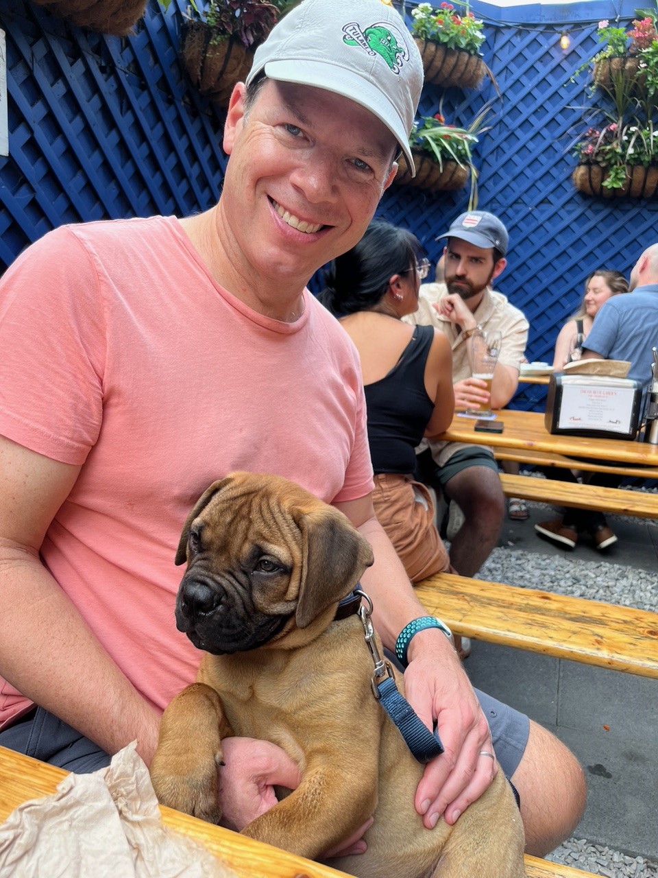 Craig with a puppy on a patio