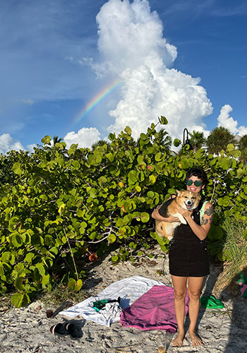 Drea and dog under rainbow