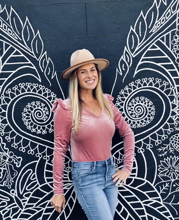 Presley posing in front of mural